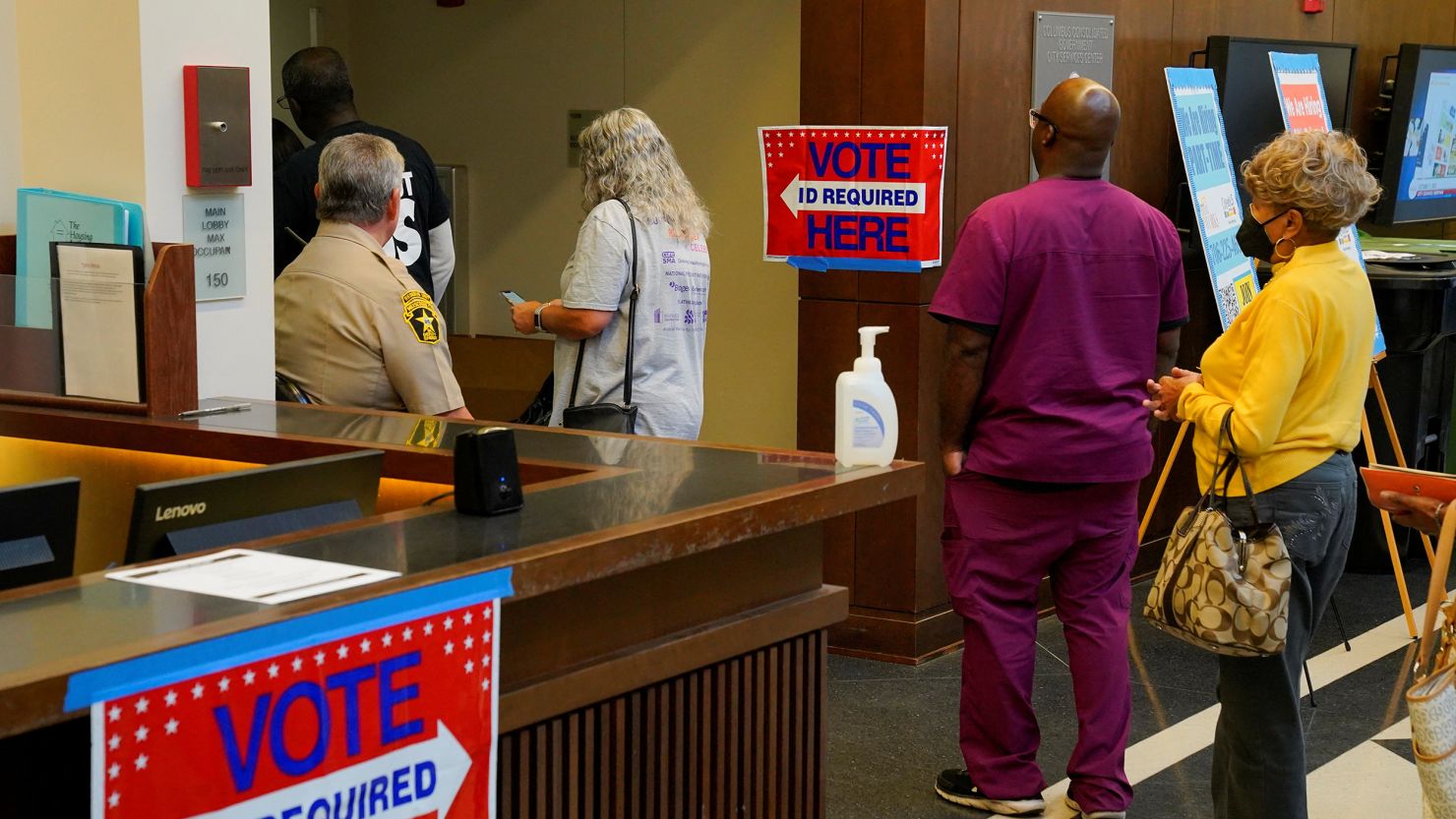 A line of early voters file down the hall as early voting begins for the midterm elections at the Citizens Service Center in Columbus, Georgia, October 17, 2022. 