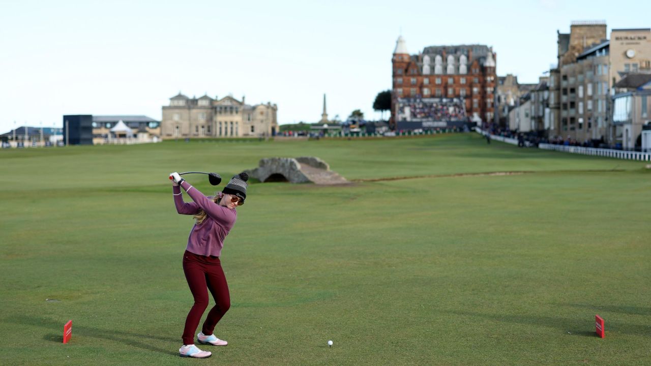 Newton drives down the famous 18th fairway at St. Andrews.