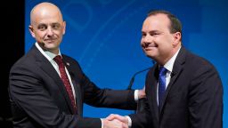 Utah Republican Sen. Mike Lee, right, and his independent challenger Evan McMullin shake hands before their televised debate, Monday, Oct. 17, 2022, in Orem, Utah, three weeks before Election Day. 