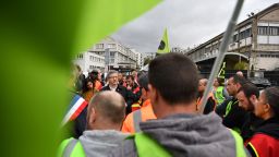 Founder of La France Insoumise (LFI) and member of left-wing coalition NUPES (New People's Ecologic and Social Union) Jean-Luc Melenchon (L) looks on as he attends a general assemby of railway workers in Gare de Lyon, in Paris, on October 18, 2022 after the CGT and FO trade unions called for a nationwide strike for higher salaries, and against the government's requisitioning of fuel refineries to force some strikers back into opening fuel depots. - Unions in other industries and the public sector have also announced action to protest against the twin impact of soaring energy prices and overall inflation on the cost of living. (Photo by JULIEN DE ROSA / AFP) (Photo by JULIEN DE ROSA/AFP via Getty Images)