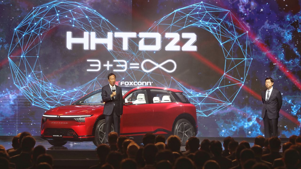 Terry Gou, founder of Foxconn Technology Group, left, unveils the Model B crossover at an event in Taipei, Taiwan.