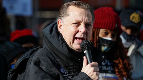 Rev. Michael Pfleger speaks before a march against gun violence on the Magnificent Mile in Chicago, Illinois, on December 31, 2020.