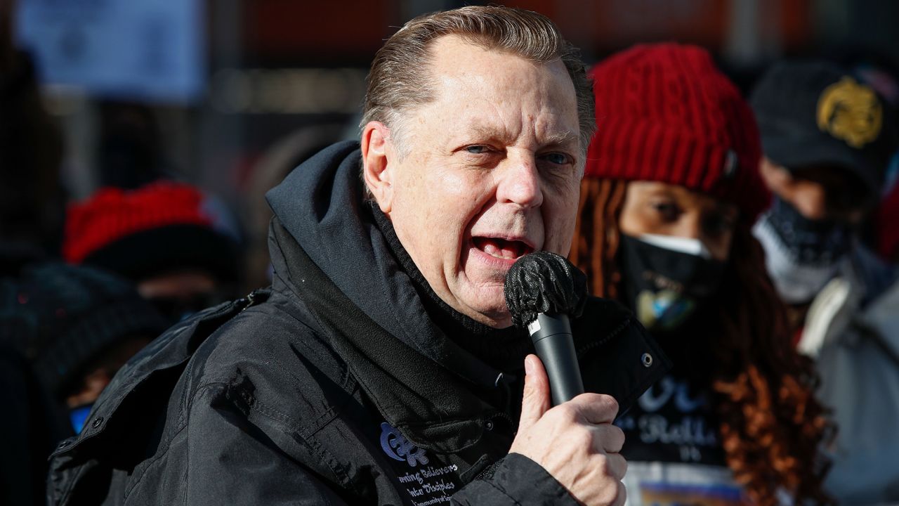 Activist Catholic Priest the Rev. Michael Pfleger speaks before march against gun violence on the Magnificent Mile in Chicago in December 2020.