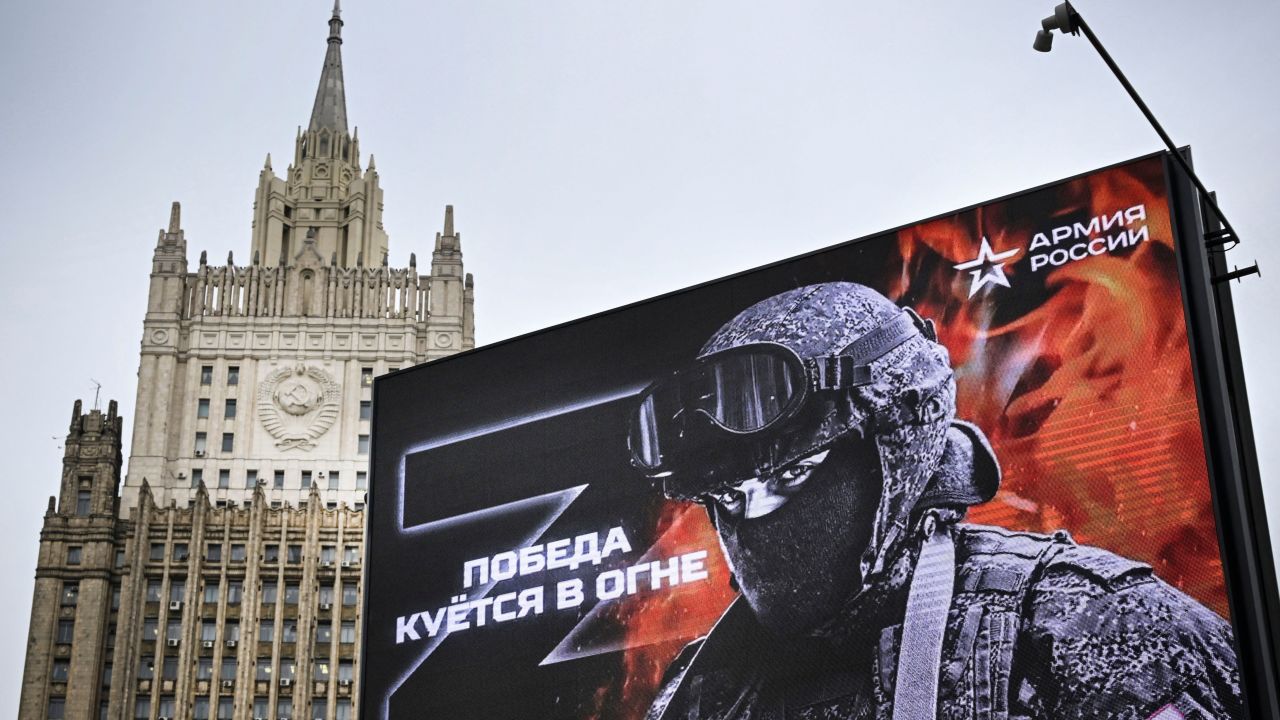 TOPSHOT - Russian Foreign Ministry building is seen behind a social advertisement billboard showing Z letters - a tactical insignia of Russian troops in Ukraine and reading "Victory is being Forged in Fire" in central Moscow on October 13, 2022. - Five Russians drafted to fight in Ukraine, as part of the "partial" mobilization ordered in September, died after joining the army, authorities said, as similar announcements have multiplied in recent days. (Photo by Alexander NEMENOV / AFP) (Photo by ALEXANDER NEMENOV/AFP via Getty Images)