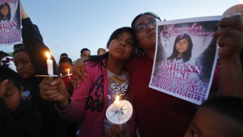 In this May 4, 2016, photo, Klandre Willie, left, and her mother, Jaycelyn Blackie, take part in a candlelight vigil in Lower Fruitland, New Mexico, for Ashlynne Mike, who was abducted and left for dead in a remote Navajo place.  Nation.  (Jon Austria/The Daily Times via AP, File)
