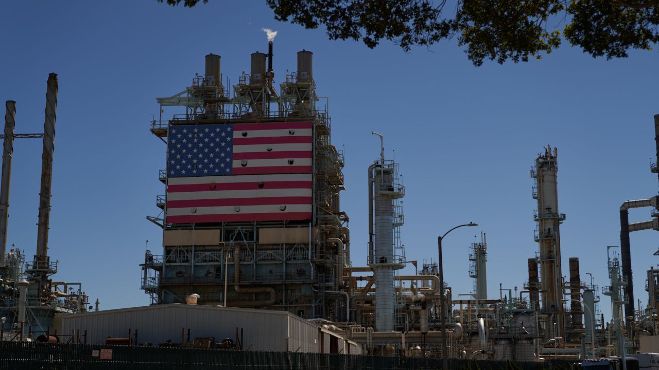 WILMINGTON, CA - SEPTEMBER 21: An oil refinery displays an American flag on September 21, 2022 in Wilmington, California. Gas prices have increased for the first time in almost 100 days. (Photo by Allison Dinner/Getty Images)