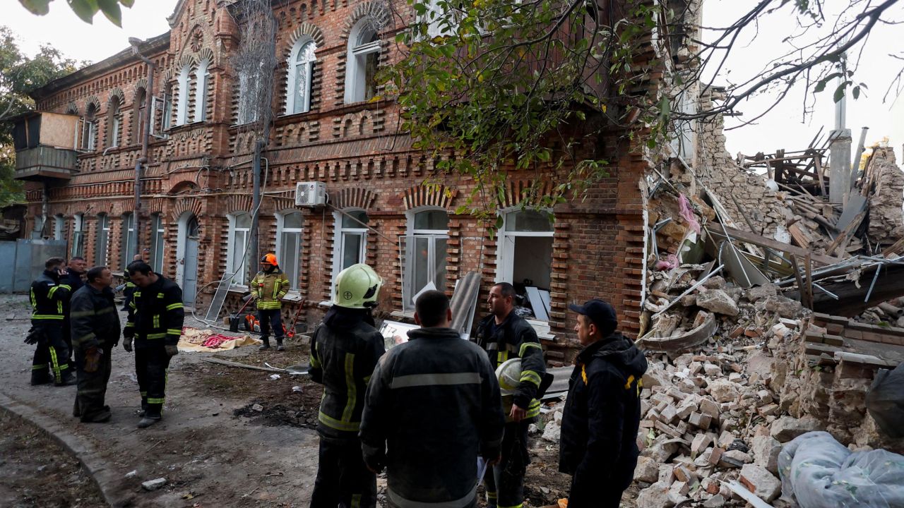 Rescuers stand near a building heavily damaged by a Russian missile strike, amid Russia's attack on Ukraine, in Mykolaiv, Ukraine October 18, 2022. REUTERS/Valentyn Ogirenko