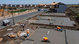 Contractors work on concrete slabs in the Cielo at Sand Creek by Century Communities housing development in Antioch, California, U.S., on Thursday, March 31, 2022. 