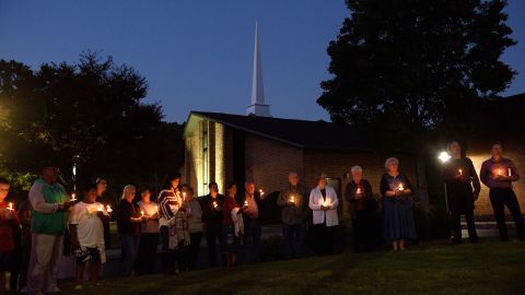 Mourners gather at Beacon Baptist Church for a vigil after five people were gunned down in Raleigh.