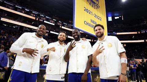 Andre Iguodala, Steph Curry, Draymond Green and Klay Thompson pose with their championship rings in front of a championship banner prior to their season opener against the Los Angeles Lakers at Chase Center on October 18.