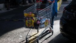 A customer pushes a shopping cart in the parking lot of the Carrefour SA hypermarket in the Grand Littoral retail park in Marseille, France, on Monday, July 25, 2022. 