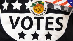 A poll worker wears an "I'm a Georgia Voter" sticker at the Metropolitan Library polling location on May 24, 2022 in Atlanta, Georgia. Voters across Georgia will be voting on several positions, including U.S. Senate seats, Georgia Secretary of State, and the Governor position.