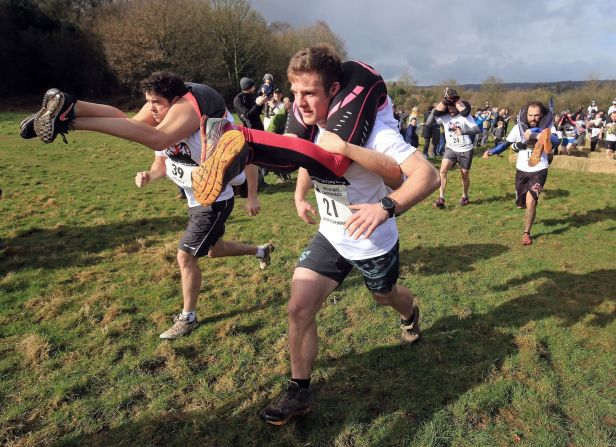 <strong>Wife carrying:</strong> Originating in Finland, this is a race in which male contestants must carry a female using one of three postures: piggyback, over the shoulder, or "Estonian-style," meaning the woman is upside down with her legs over the man's shoulders (pictured). A world championship has been held annually since 1997 and the sport has now expanded to more countries, including England.