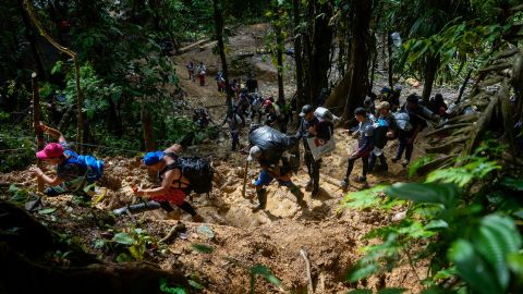 Migrants, mostly Venezuelans, trek across the Darien Gap from Colombia into Panama on October 15, 2022, on their way towards the US.