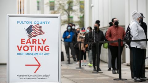 Voters line up for the first day of early voting outside of the High Museum polling station on December 14, 2020 in Atlanta, Georgia. 