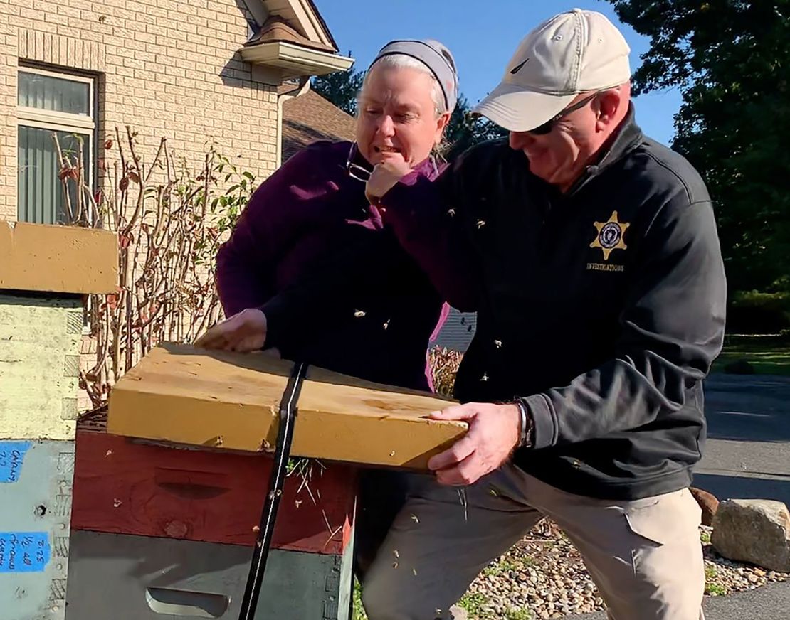 A Massachusetts woman who unleashed bees on deputies tussles with a Hampden County Sheriff's deputy on October 12, 2022. 