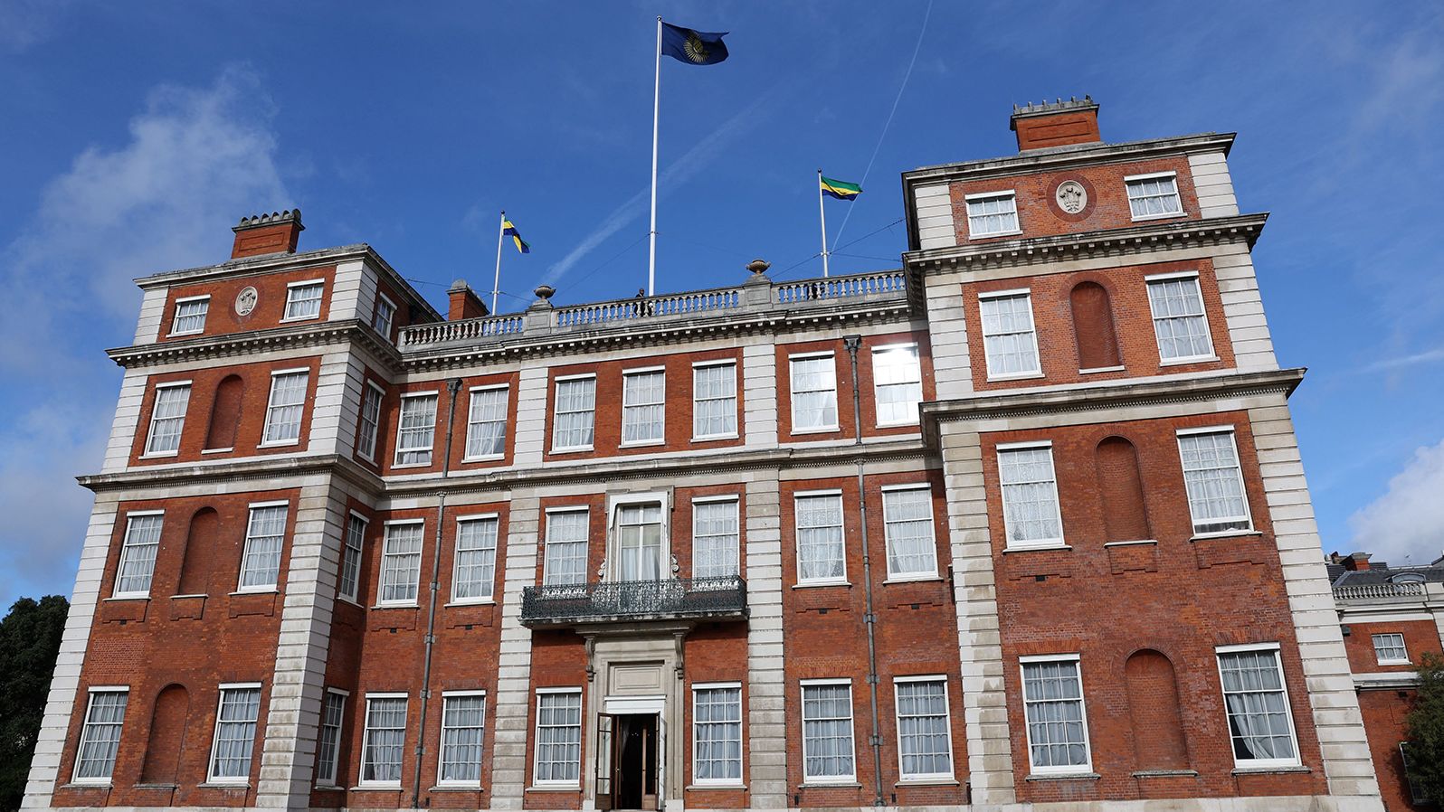 Gabonese flags are raised next to the Commonwealth flag during a ceremony to mark the accession of Gabon to the Commonwealth at the organization's headquarters in London on October 17.