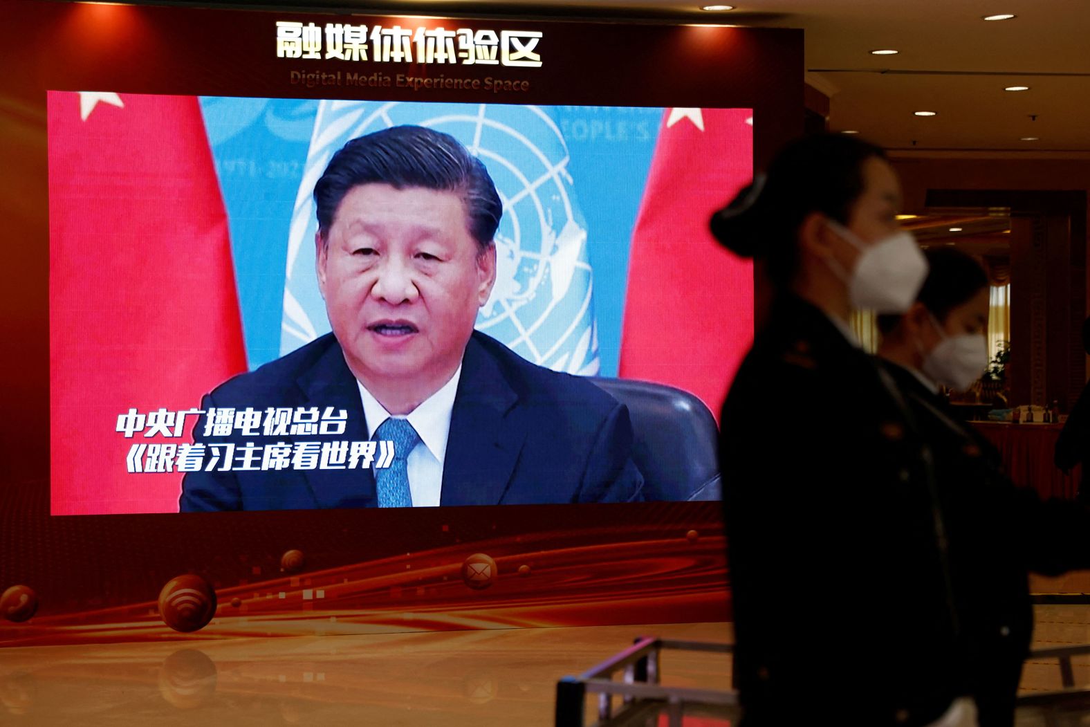 Xi appears on a screen at a hotel hosting the media in Beijing on October 19.