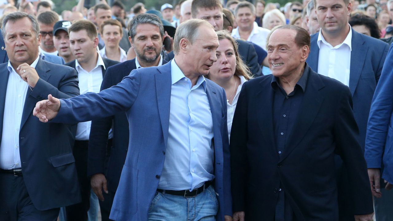 Russian President Vladimir Putin (center left) and former Italian Prime Minister Silvio Berlusconi on September 11, 2015 in Crimea. 