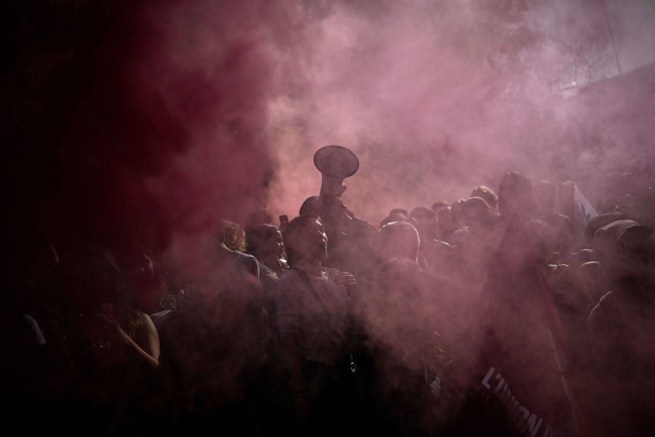 Protesters stand in the smoke of flares during a demonstration in Marseille, France, on Tuesday, October 18. France is in the grip of transport strikes that have sparked chronic gasoline shortages around the country.