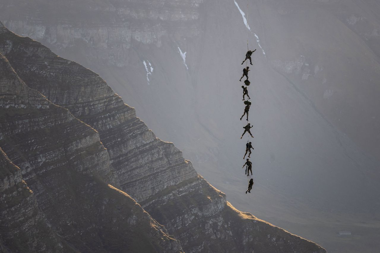 Soldiers of the Swiss special forces command perfom, suspended from an helicopter, over the Axalp in the Bernese Oberland on Wednesday, October 19. At an altitude of 2,200 meters above sea level, spectators attended a unique aviation display performed at the highest air force firing range in Europe.