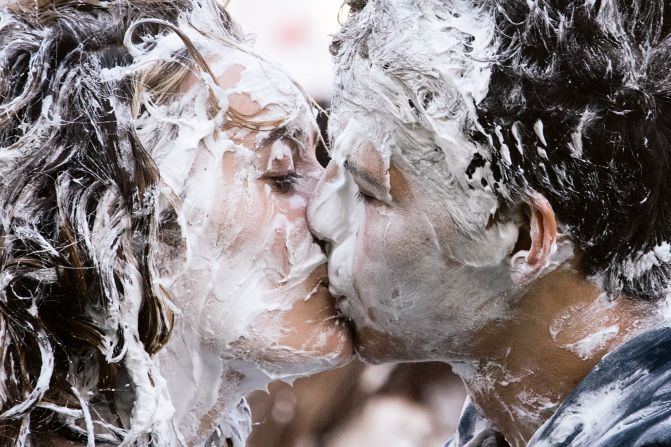First-year students of the University of St. Andrews kiss as they take part in the annual "Raisin Monday" shaving foam fight in St. Andrews, Scotland, on Monday, October 17. The event is the culmination of a week of mentoring to welcome first-year students.