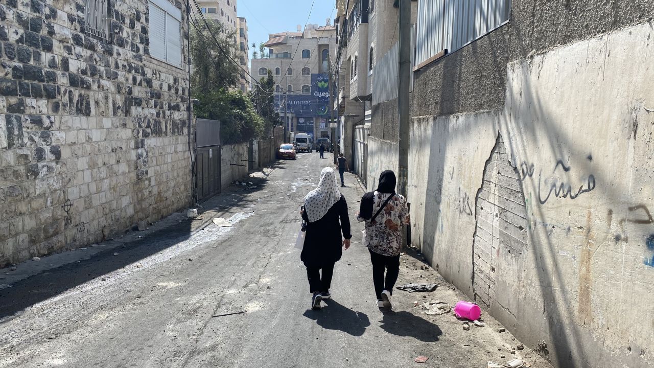 Two women walk along the narrow alleyways of the Shuafat refugee camp, in East Jerusalem on October 12.  
