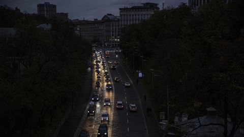 The bright headlights of cars light a darken road in Kyiv on October 20.