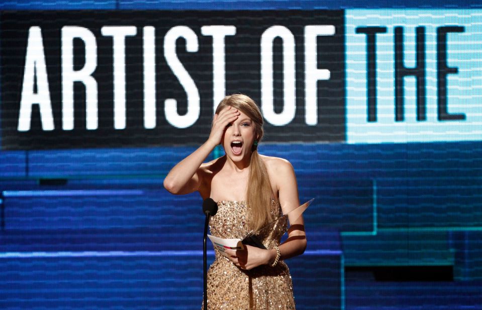 Swift accepts the award for artist of the year at the 2011 American Music Awards in Los Angeles.