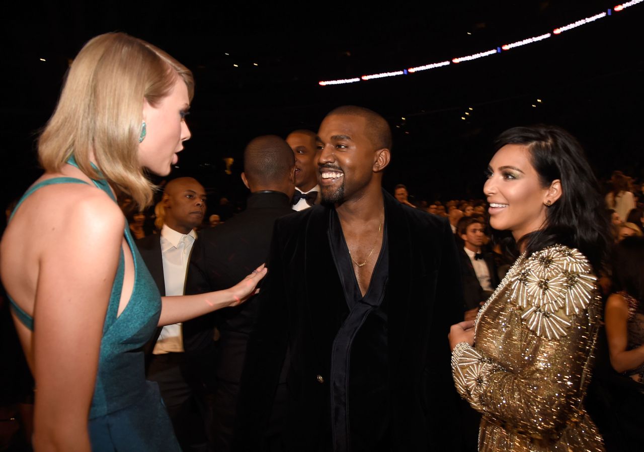 Swift, Kanye West and Kim Kardashian speak during the 2015 Grammy Awards in Los Angeles. Swift and West appeared to make amends six years after he snatched the mic from her at the 2009 VMAs.