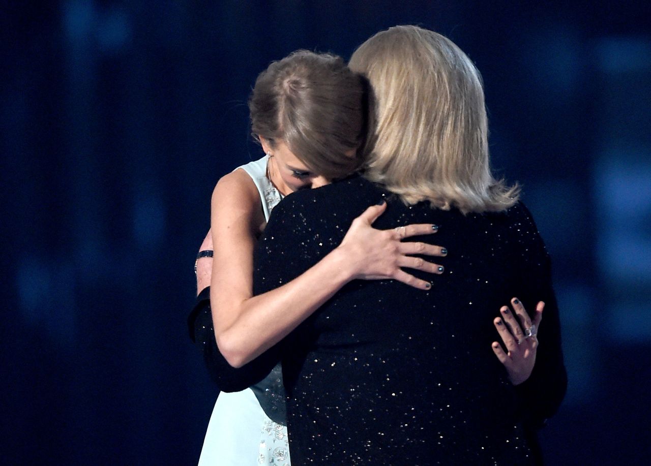 Swift accepts the Milestone Award for Youngest ACM Entertainer of the Year from her mother, Andrea, during the Academy of Country Music Awards in Arlington, Texas, in 2015.