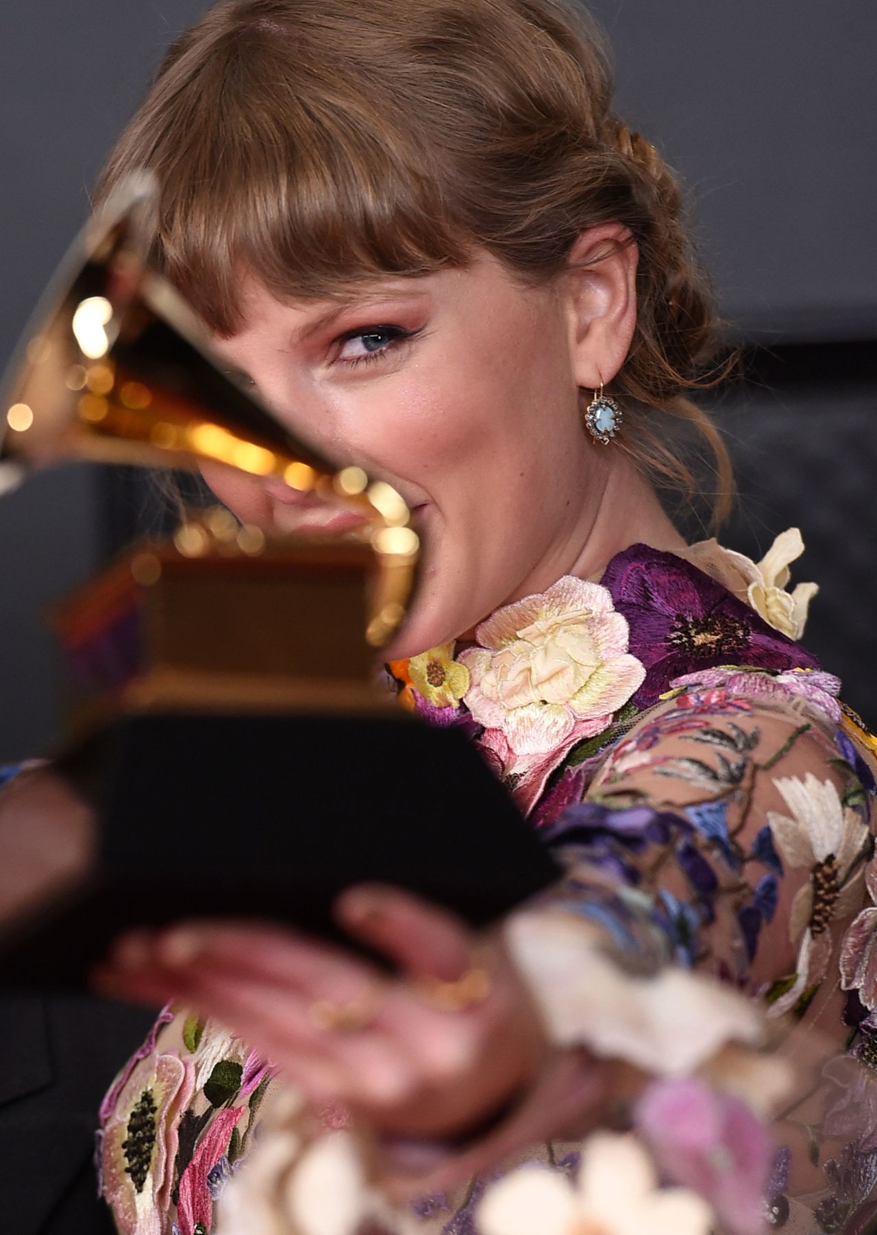 Swift poses with her album of the year award for "Folklore" at the 2021 Grammy Awards.