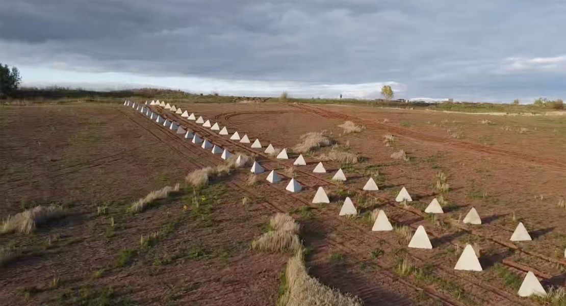 An image, taken by Russian tabloid outlet RIA/FAN, shows two rows of the anti-tank pyramids sitting in the field just outside of Russian-occupied Hirske, Ukraine.