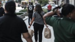 A shopper carries bags in Detroit, Michigan, US, on Wednesday, Sept. 14, 2022. 