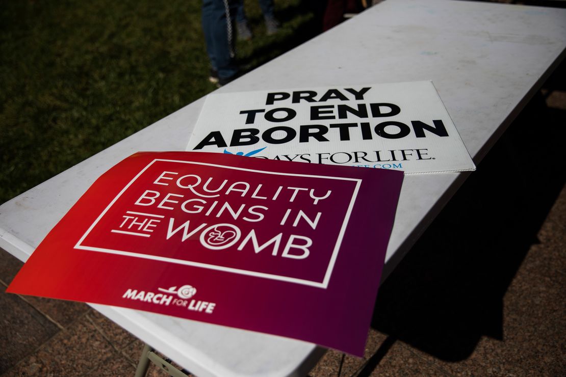 Anti-abortion signs sit on a table during the Ohio March for Life in Columbus.