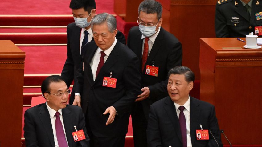 China's President Xi Jinping (R) sits beside Premier Li Keqiang (L) as former president Hu Jintao is assisted to leave from the closing ceremony of the 20th Chinese Communist Party's Congress at the Great Hall of the People in Beijing on October 22, 2022. (Photo by Noel CELIS / AFP) / The erroneous mention[s] appearing in the metadata of this photo by Noel CELIS has been modified in AFP systems in the following manner: [clarifying caption to state China's former president Hu Jintao is assisted to leave from the closing ceremony] instead of [being assisted to his seat]. Please immediately remove the erroneous mention[s] from all your online services and delete it (them) from your servers. If you have been authorized by AFP to distribute it (them) to third parties, please ensure that the same actions are carried out by them. Failure to promptly comply with these instructions will entail liability on your part for any continued or post notification usage. Therefore we thank you very much for all your attention and prompt action. We are sorry for the inconvenience this notification may cause and remain at your disposal for any further information you may require. (Photo by NOEL CELIS/AFP via Getty Images)