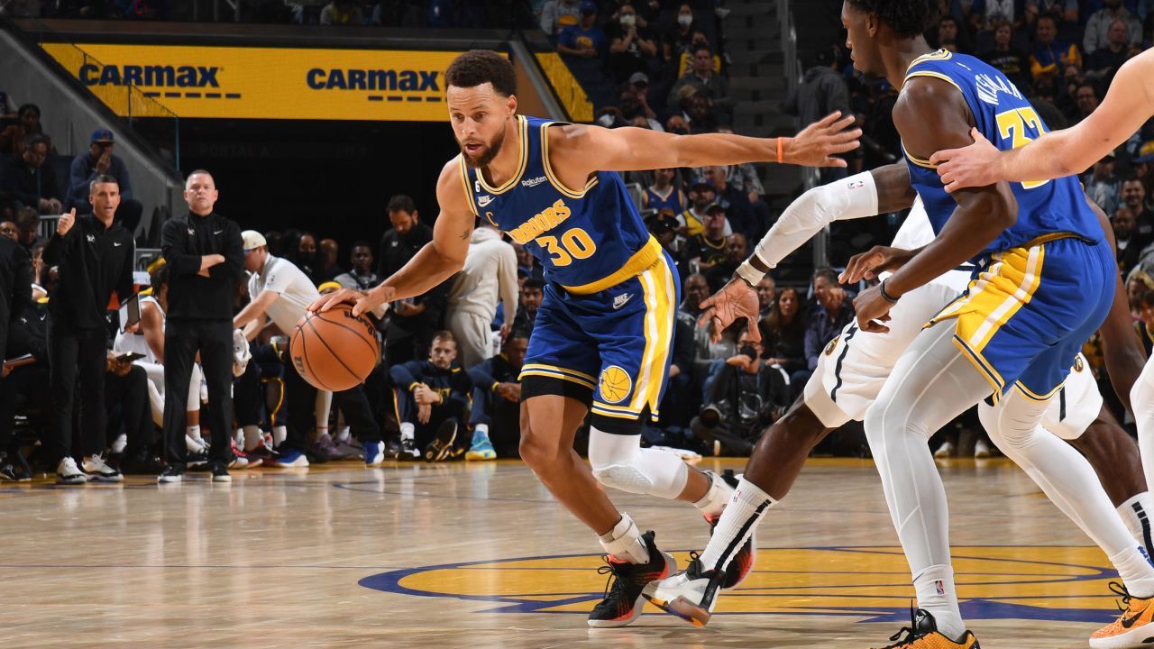 Curry dribbles the ball against the Denver Nuggets at Chase Center in San Francisco, California. 