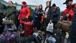 Evacuees from Kherson gather upon their arrival at the railway station in Dzhankoi, Crimea, Friday, Oct. 21, 2022. Russian authorities have encouraged residents of Kherson to evacuate, warning that the city may come under massive Ukrainian shelling. 