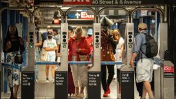 Commuters walk through the Times Square subway station in New York, US, on Thursday, June 30, 2022. The head of New York's Metropolitan Transportation Authority warned the agency's anticipated $2 billion budget gap may widen in 2026 as it struggles to win back riders.