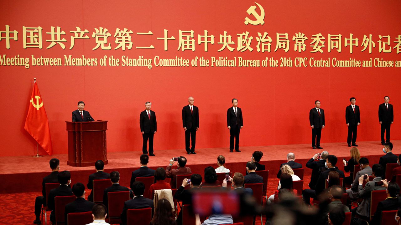 The new Politburo Standing Committee members assemble in the Great Hall of the People in Beijing.