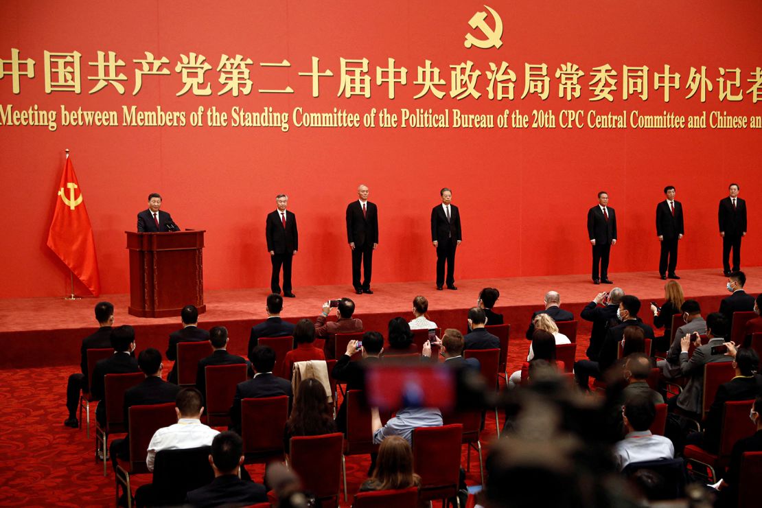 The new Politburo Standing Committee members assemble in the Great Hall of the People in Beijing.