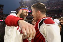 Bryce Harper of the Philadelphia Phillies celebrates with J.T. Realmuto after defeating the San Diego Padres in Game 5 to win the National League Championship Series on October 23, 2022 in Philadelphia.