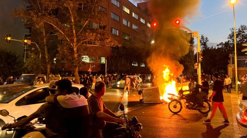 A police motorcycle burns during a protest in Tehran on September 19 over the death of Mahsa Amini.