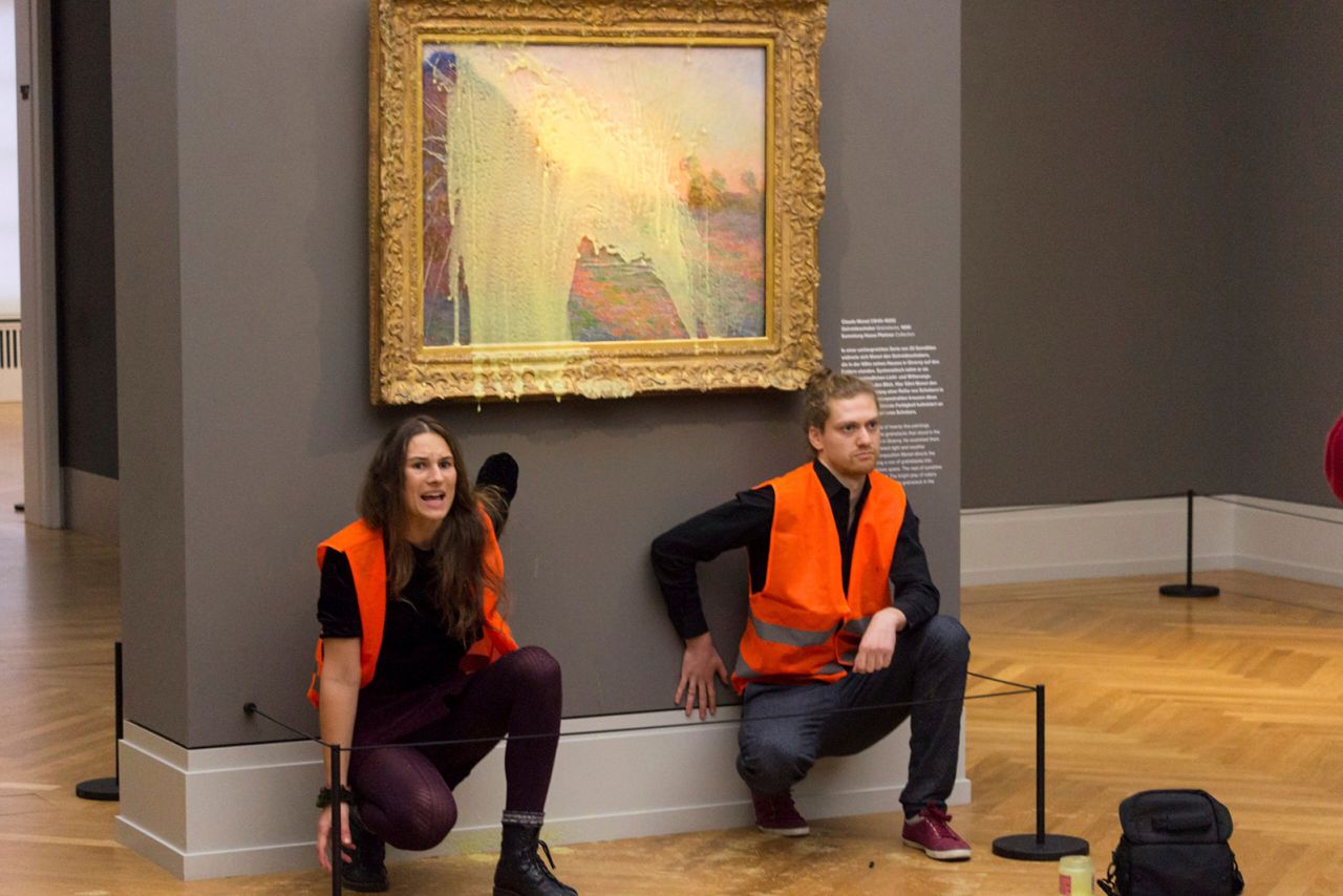 Climate protesters of Last Generation after throwing mashed potatoes at the Claude Monet painting "Les Meules."