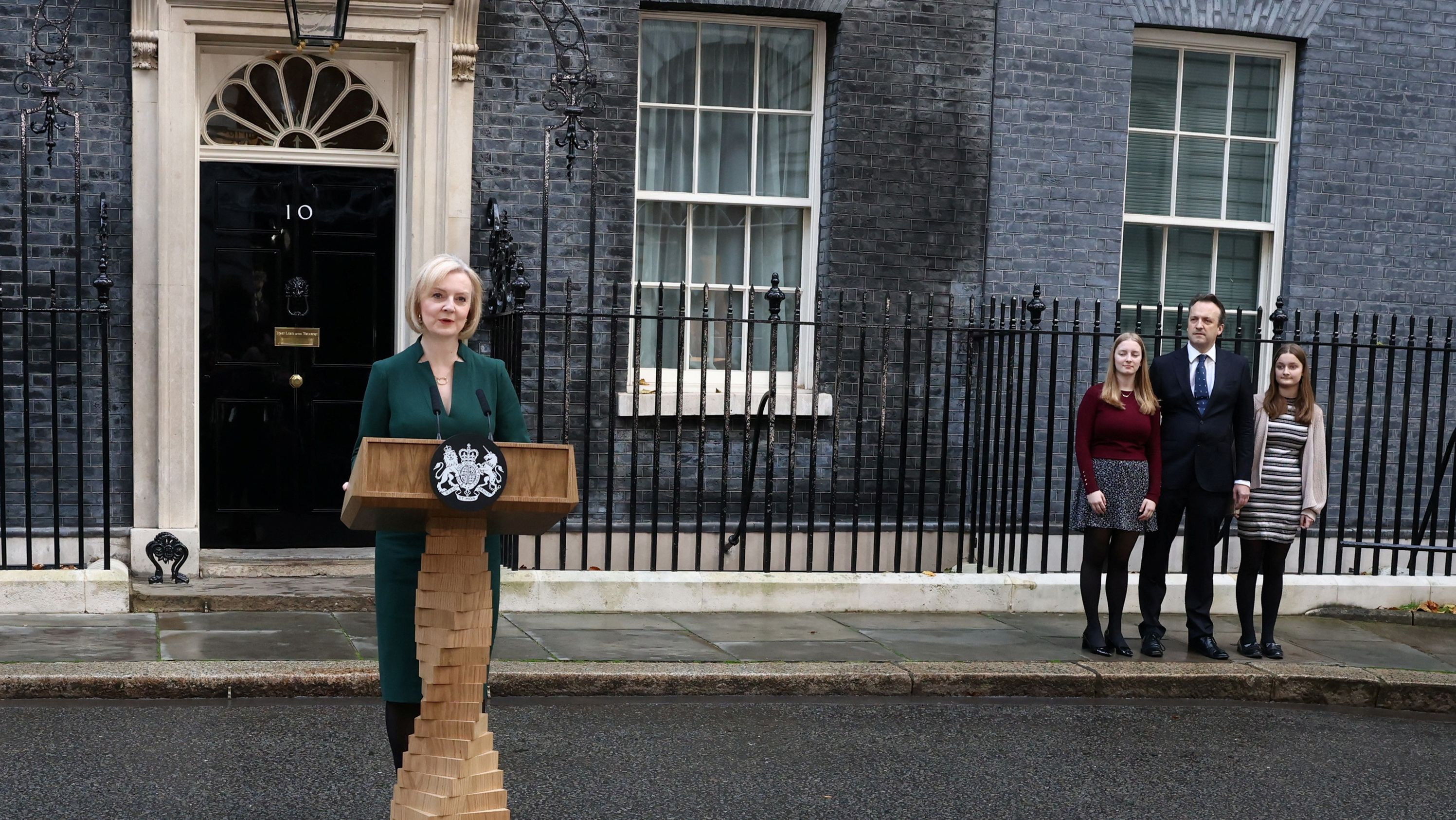 Truss delivers a speech on her last day in office as her husband, Hugh, and her daughters, Frances and Liberty, watch outside No. 10 Downing Street in October 2022. She was prime minister for six weeks.