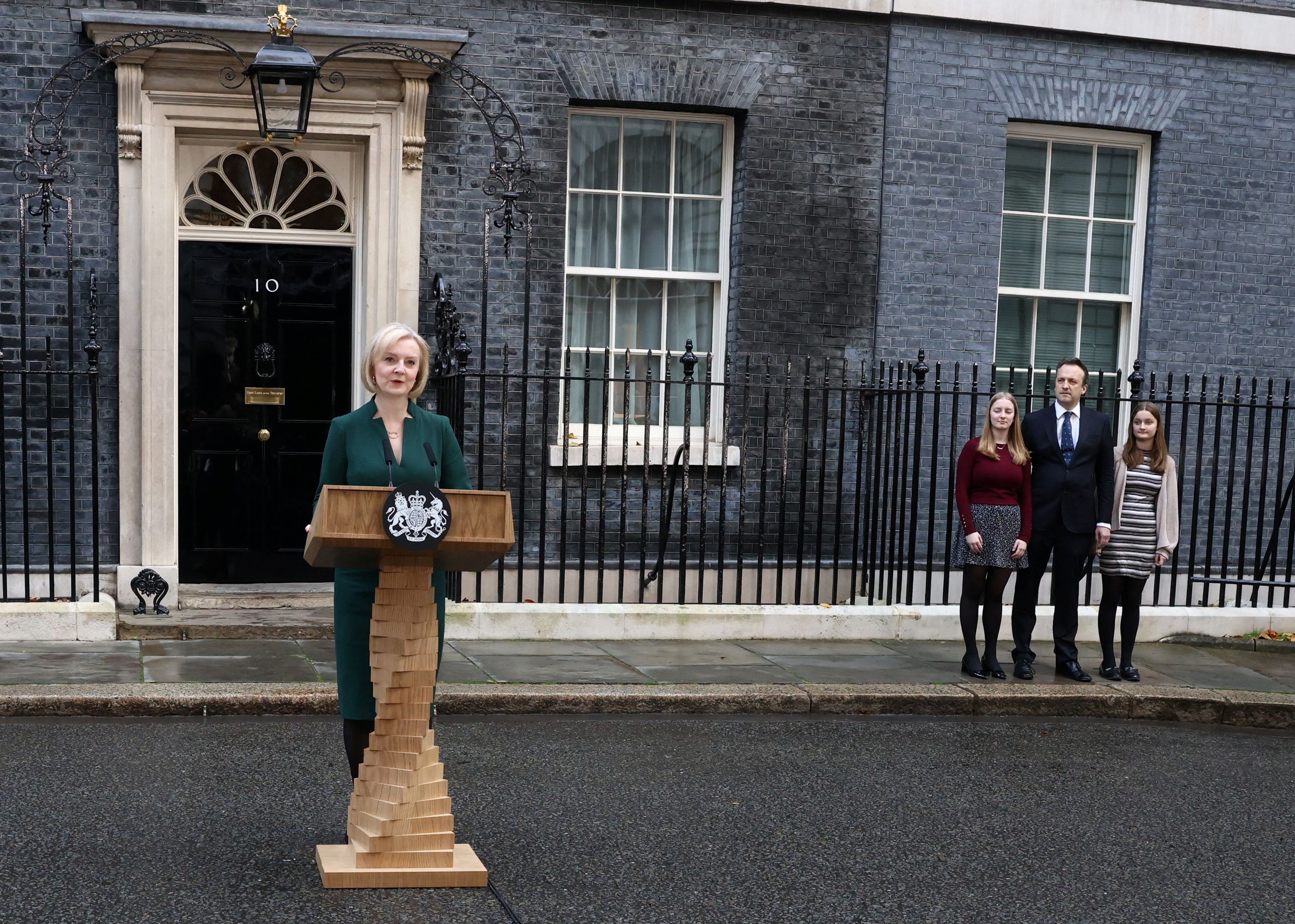 Truss delivers a speech on her last day in office as her husband, Hugh, and her daughters, Frances and Liberty, watch outside No. 10 Downing Street in October 2022.