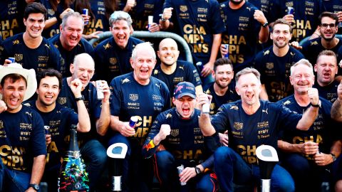 Verstappen poses with the Red Bull team to celebrate winning the constructors' championship.