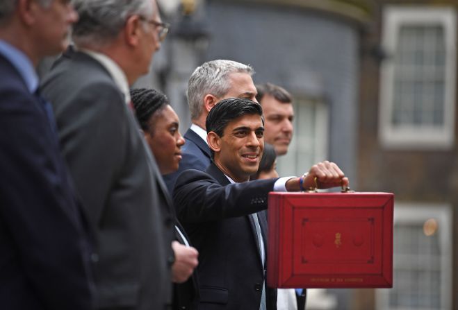 Sunak is seen outside 11 Downing Street in London before heading to the House of Commons to deliver his budget in March 2020.