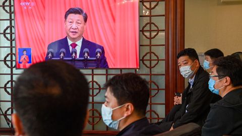 Officials watch the opening session of the 20th National Congress of the Communist Party of China (CPC) on TV in Qingdao, Shandong province, eastern China on Sunday, October 16, 2022. 