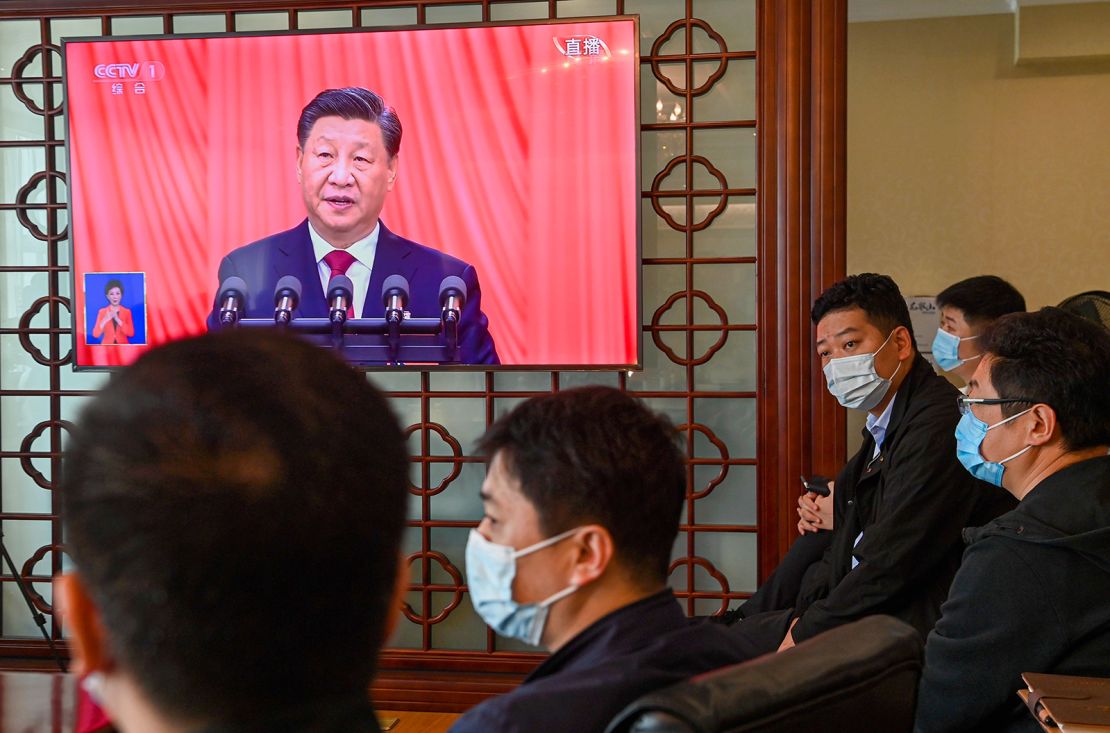 Officials watch the opening session of the 20th National Congress of the Communist Party of China (CPC) on a TV in Qingdao in east China's Shandong province Sunday, Oct. 16, 2022. 